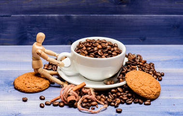 Fresh roasted coffee beans. Caffeine concept. Coffee shop concept. Cafe drinks menu. Coffee break and relax. Inspiration and energy charge. Cup full coffee brown roasted bean blue wooden background