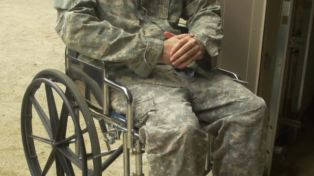 military man nervous in wheelchair outside