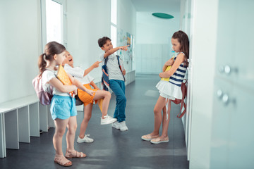 Children laughing and bullying their new classmate