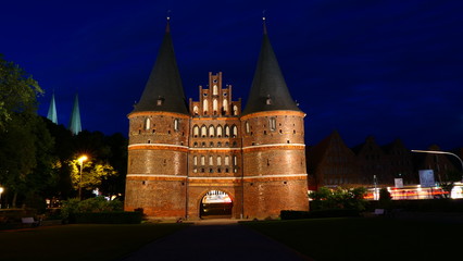 Fototapeta na wymiar The famous Holsten Gate at night in Lubeck, Germany