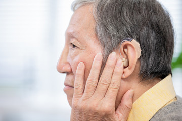 Fototapeta premium elder patient wear audiphone