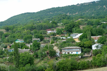 Fototapeta na wymiar View of country houses and gardens on mountains hills, trees and bushes. Rossoshanka village, Crimea,Ukraine