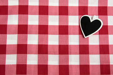 Black heart on checkered tablecloth
