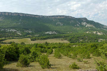Fototapeta na wymiar View of mountains hills, trees and bushes. Vysokoe (Kermenchik) village, Crimea,Ukraine