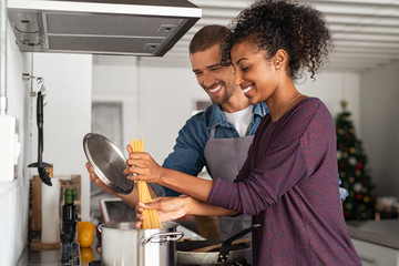 Young couple cooking italian pasta