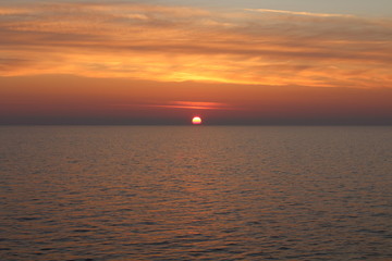 Obraz premium evocative image of sunrise over the sea with the sun rising over the horizon