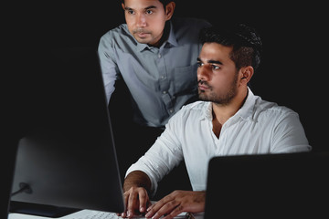 Asian businessman coworkers working night shift in the office