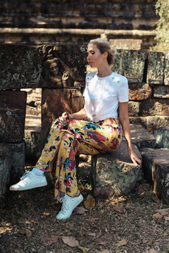 Young female tourist traveler is posing at Angkor Wat temple, Siem Reap, Cambodia