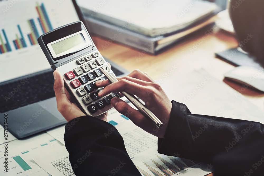 Aufkleber business accounting finance concept. accountant using calculator for calculate with laptop working i