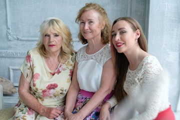 Three generations of women in the family in one photo. An adult daughter, her mother and grandmother. Beautiful old women, noble and beautiful old age. Family history