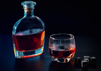 Bottle of cognac or whiskey with full glass