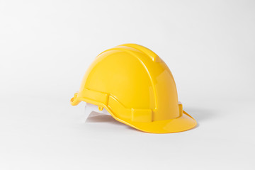 Yellow Plastic safety helmet for engineer on gray background.