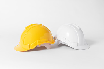 Plastic safety helmet for engineer on gray background.