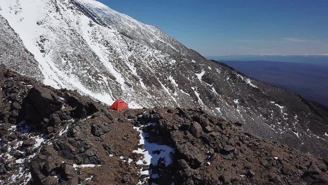 Drone shot orbiting a shelter tent on top of the mountain. Baikal, Siberia