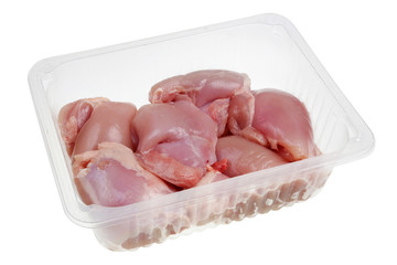 Chicken meat fresh legs  without  bones and skin in the standard  opened plastic container isolated
