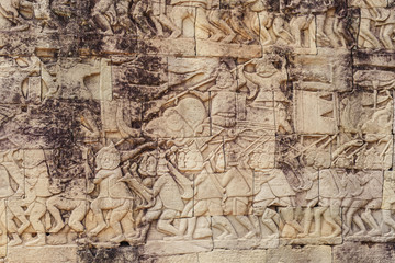Fototapeta na wymiar Ancient Khmer carving bas-relief. Wall of Bayon Temple, Angkor Thom, Siem Reap, Cambodia