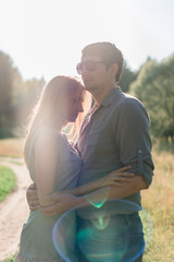 young couple in love on nature at sunset