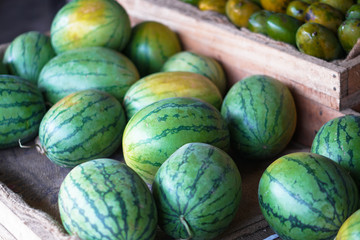 Watermelons and melons are sold on the market in Asia. Sale of vegetarian fruits outdoors. Stock photos