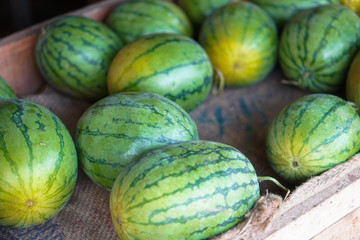 Watermelons and melons are sold on the market in Asia. Sale of vegetarian fruits outdoors. Stock photos