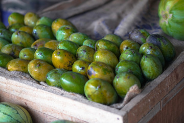 Mangoes are sold on the market in Asia. Sale of vegetarian fruits outdoors. Stock photo