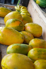 Papayas are sold on the market in Asia. Sale of vegetarian fruits outdoors. Stock photo