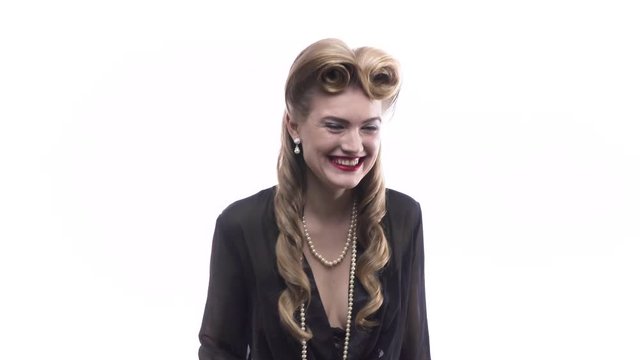 Funny blonde girl with retro hairstyle is fooling around, 4k
