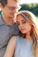 Fototapeta premium young couple in love on nature at sunset