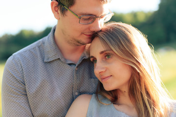 Fototapeta premium young couple in love on nature at sunset