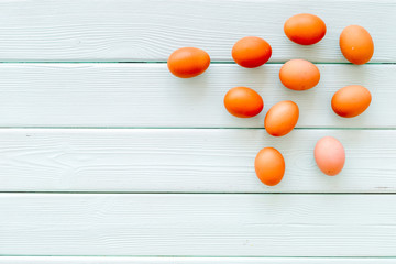 Farm products with eggs on mint green wooden background top view mock up