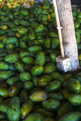 Mangoes are sold on the market in Asia. Sale of vegetarian fruits outdoors. Stock photo