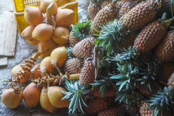 Pineapples are sold on the market in Asia. Sale of vegetarian fruits outdoors. Stock photo