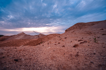 Coal mining at an open pit at sunset