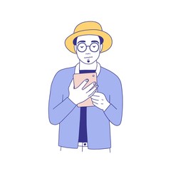 Young hipster man dressed in stylish clothes reading e-book