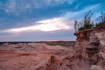 Coal mining at an open pit at sunset