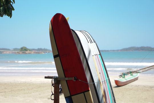 Surfboard parking on the beach of the Indian Ocean. Beautiful view of the sea and sand. Stock photo