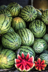 Watermelons and melons are sold on the market in Asia. Sale of vegetarian fruits outdoors. Stock photos