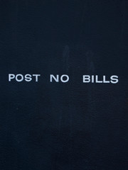 A sign on a wall prohibits posting bills to it. Very clean only with graphics.