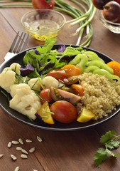 Vegetarian salad with quinoa, vegetables and sunflower seeds. Buddha bowl, vertical 