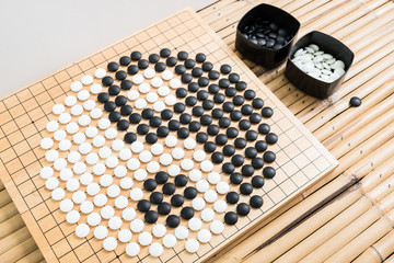 yin yang symbol go game. igo chinese board game with black and white ston, Japan Go