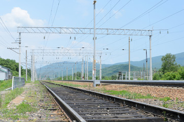 Fototapeta na wymiar Railway tracks in mountainous terrain extending into perspective
