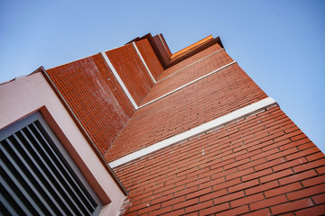 Building red brick house on sky background, bottom view