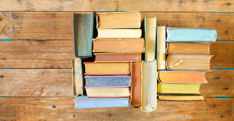 Multicolored books, flat lay, on wooden background, reading, education, literature,learning