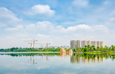 Naklejka premium Buildings and cranes around Jincheng Lake in Chengdu, Sichuan Province, China
