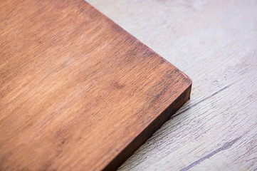 Cutting board for the kitchen on wooden table.