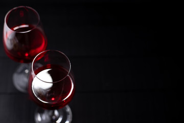 Red wine in glass on dark background.