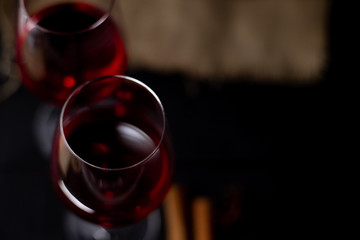 Red wine in glass on dark background.