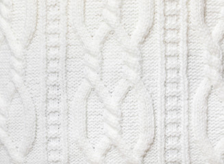 Fototapeta na wymiar White cable knitting fabric textured background