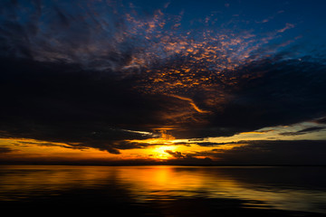 Fototapeta na wymiar Sunset sky at the lake with rain cloud.