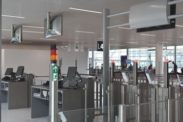 Picture of new equipment installed in main airports: the Automated Boarding Gate. It is the next step after the Online check-in and the Drop-Off luggages. Reduction of manpower/costs.