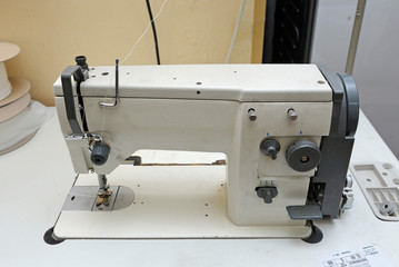 At the workshop. Electric sewing machine placed on a work table